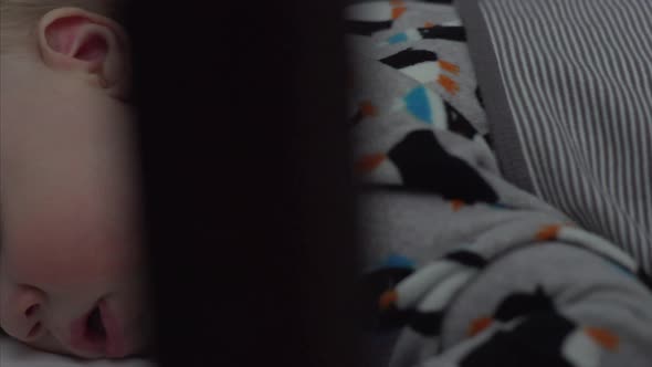 Caucasian Baby Boy Sleeping in his Crib with his Mouth Open alt