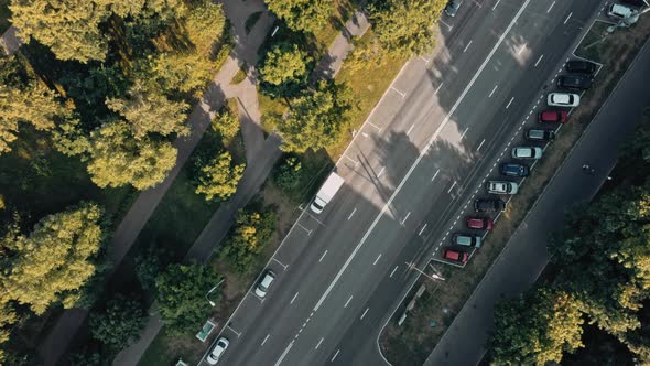 Aerial Drone View of City Road with Cars Driving Near Park