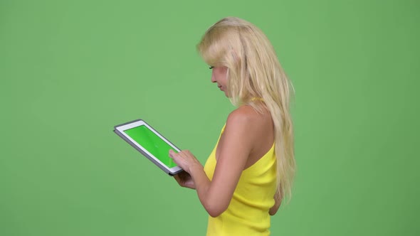 Young Beautiful Blonde Woman Using Digital Tablet