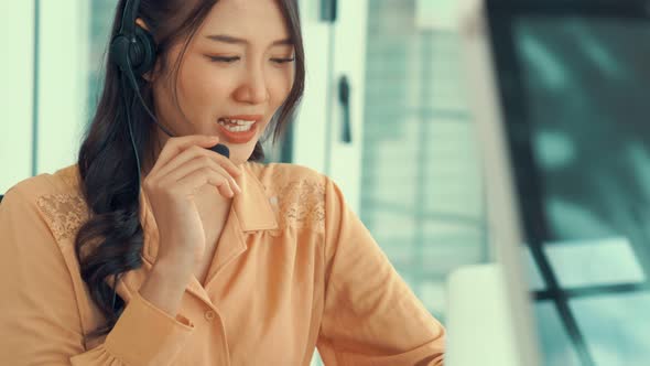 Businesswoman Wearing Headset Working Actively in Office alt