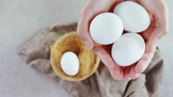Woman holding white eggs 4k alt