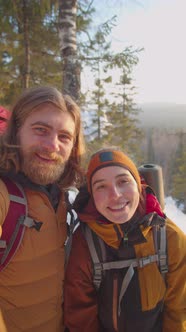 POV of Cheerful Couple Smiling and Waving on Camera in Mountains alt