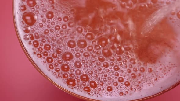 Closeup of Glass with Sparkling Rose Wine Decorated Gold Star Confetti Celebration Party alt