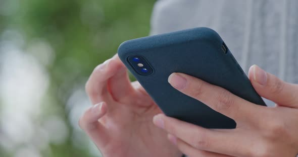 Woman use of smart phone in city alt