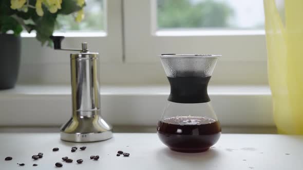 Filtering Coffee in Reusable Glass Coffee Maker alt
