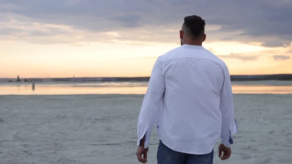 Brutal Man Walking on Beach