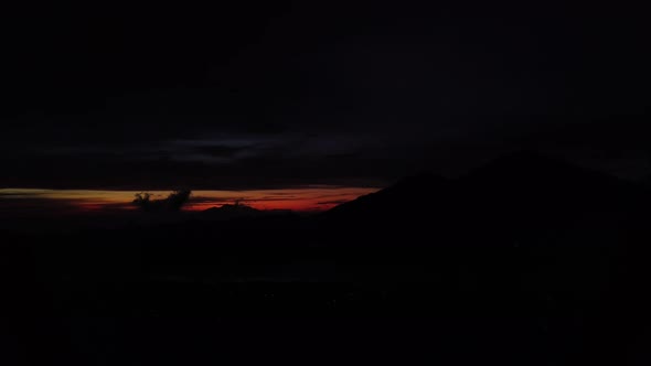Time lapse of dawn on Batur Mount viewpoint. Village on lake sunrise early morning view on mountains