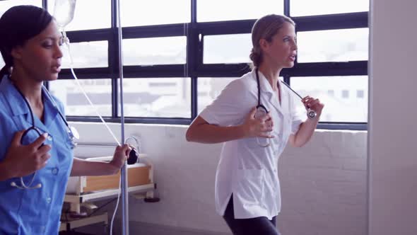 Doctor and nurse running together alt