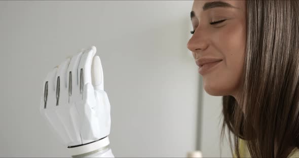 Close Up Woman Looking to Her Hightech Bionic Arm Caucasian Girl Examines and Checking Movement of alt
