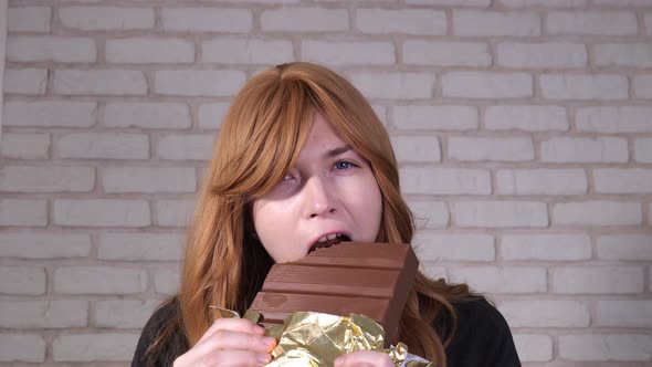Happy Girl Eating Chocolate Closeup