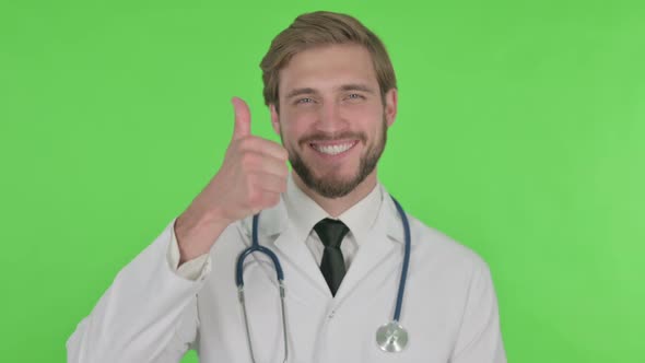 Thumbs Up By Young Doctor on Green Background alt