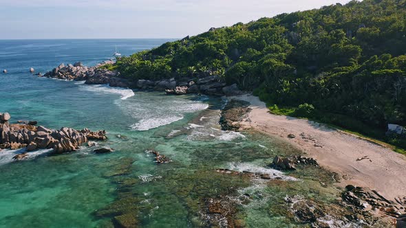 Aerial Drone View of Remote Secluded Beach with Granite Boulders at Evening Light alt