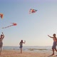 Young Family Have Fun on the Beach Playing Together with Kites - VideoHive Item for Sale