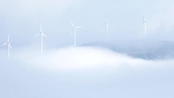 Wind Turbines in Foggy Landscape