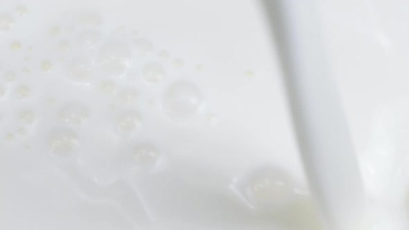 Milk Jet Pouring on Milk Surface with Waves, Whirlpools and Bubbles Slow Mo