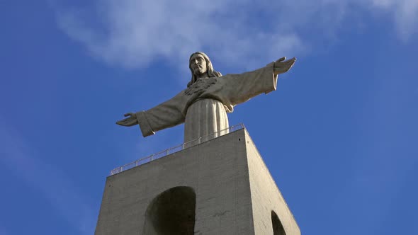 Christ King Statue Against a Blue Sky with Clouds alt