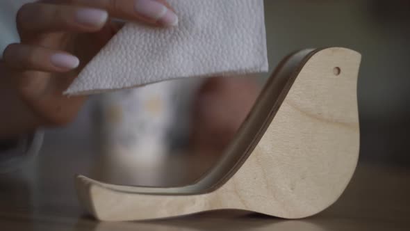 Woman Takes the Last Napkin From a Beautiful Wooden Holder in a Coffee Shop