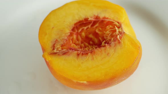 Rotation of a juicy peach. 360 degree rotation, extreme close-up. Peach orange juicy tree fruit.