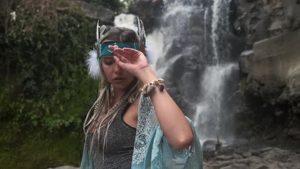 Unusual Looking Beautiful Lady at the Waterfall is Worried About Something alt