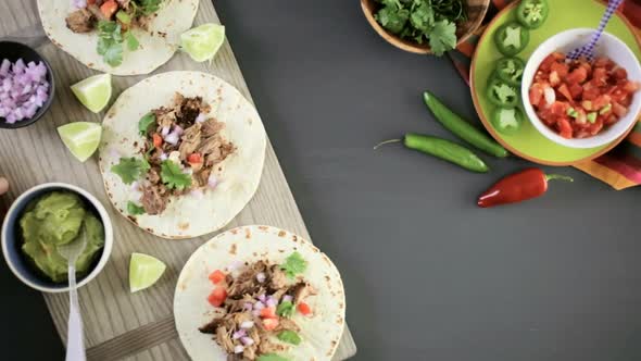 Pulled pork carnitas with pico de gallo on a flour tortilla. alt