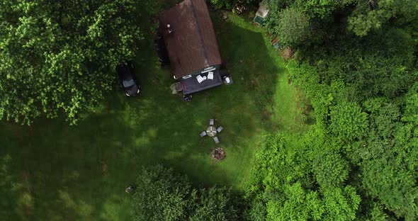 A drone shot spinning down onto a secluded cabin in the Catskill Mountains. alt