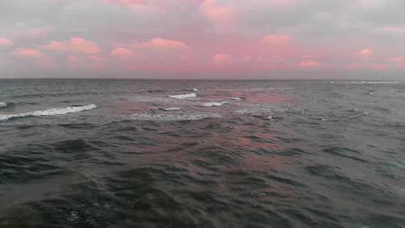 An Aerial View of the Flight Over the Baltic Sea Coastline in the Evening Just After Sunset. Concept alt