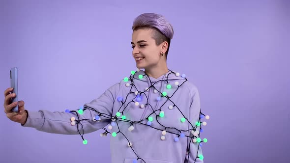 Happy Lgbt Person Vlogging Blogging Hung with Festival Lights Indoors alt