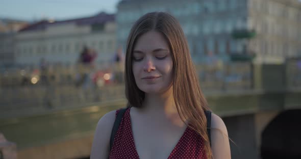 Portrait of a Young Beautiful Girl in the City in the Setting Sun