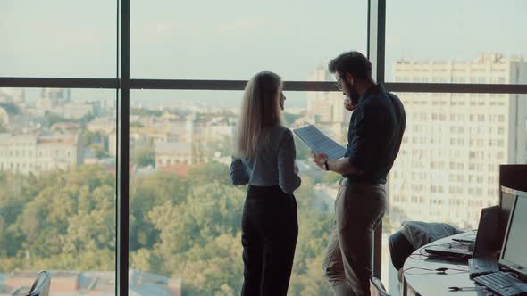 Coworkers Toghether Brainstorming In Office.Two Colleagues Talking In Office About Business Project. alt