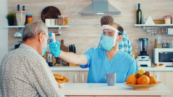 Caregiver Measuring Senior Temperature alt