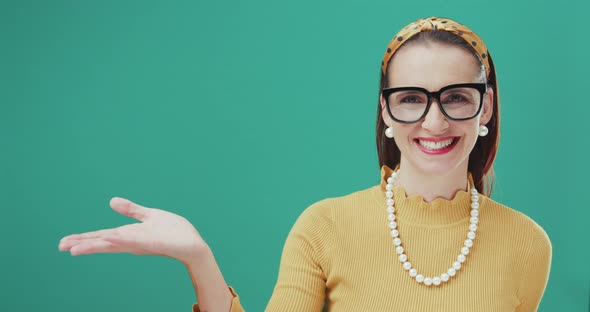 Cheerful woman smiling and showing something at her side