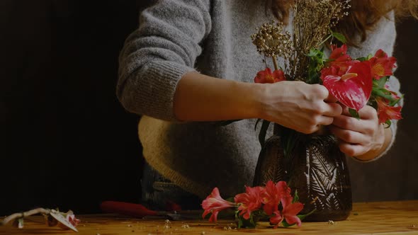Florist Makes Flower Arrangement alt