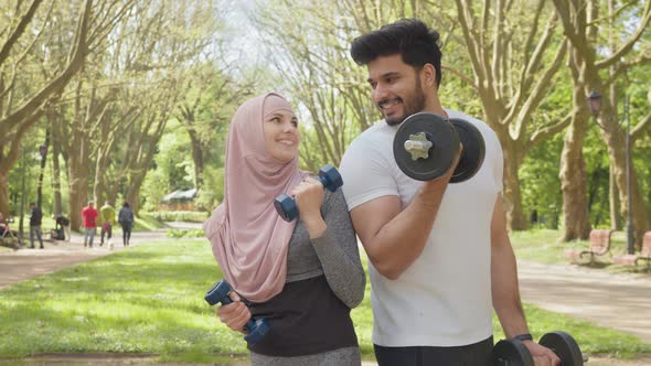 Happy Young Arabian Couple in Sport Clothes Having Morning Workout at Summer alt