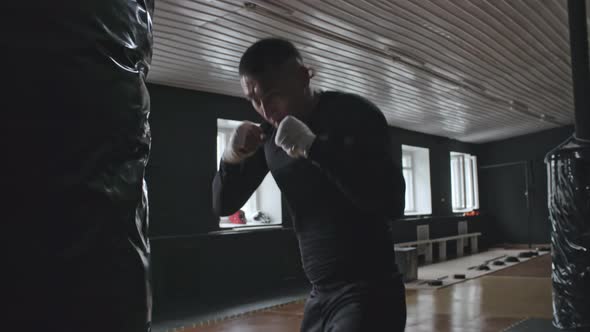 Man Exercising with Punching Bag alt