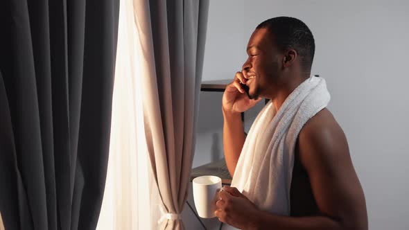 Morning Call Relaxed African Man Speaking on Phone alt
