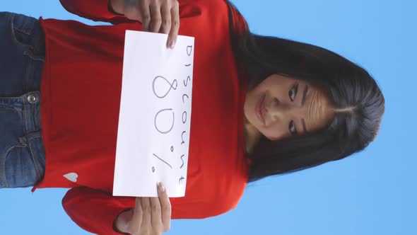 Young Woman Holding Discount Sign alt