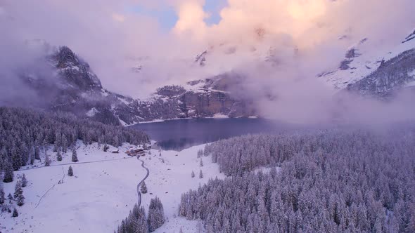 Oeschinen Lake in the Snowy Mountains of Switzerland on a Foggy Morning alt