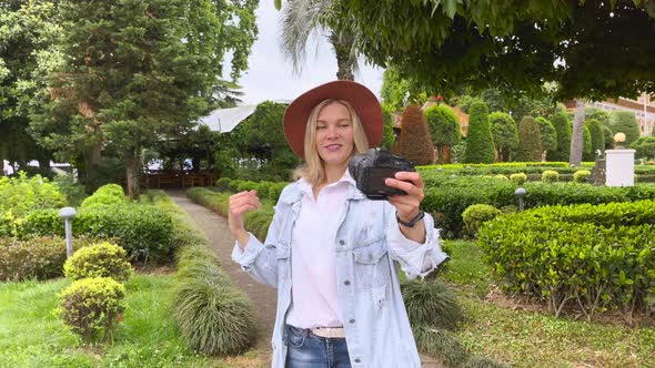 Blogger Filming Herself on Camera in the Garden