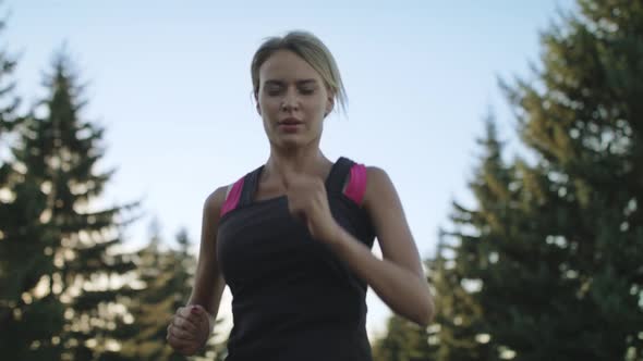 Young Woman Runner Training in Summer Park. Close Up Fit Woman Jogging Outdoor alt