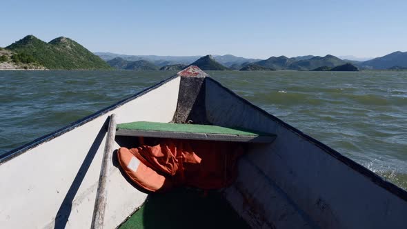 Old vintage Motor Boat Floats on the Calm  Skadar lake Water Surface Summer day alt