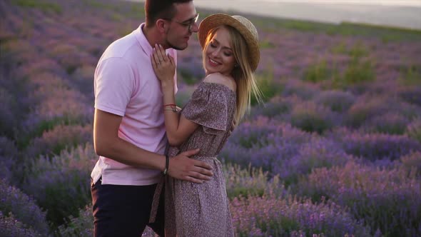 Young Couple Kisses in Flowering Lavender Field, Slow Motion alt