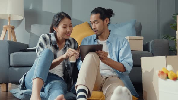 Happy asian young attractive couple man and woman use tablet online shopping furniture.