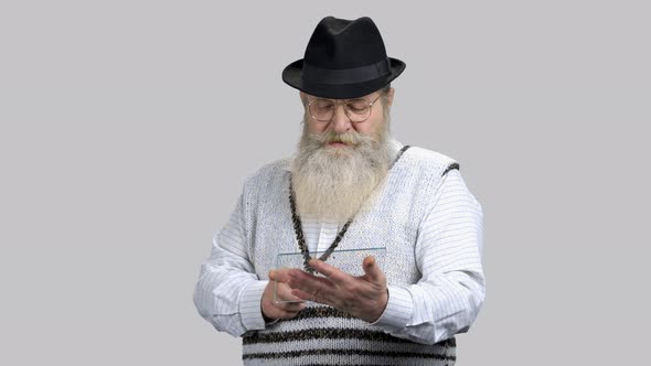 Old Bearded Man Scrolling and Swiping Glass Transparent Copyspace Tablet alt