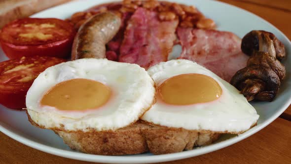 English Breakfast Close Up Fried Eggs Sausages Bacon Tomatoes Tomato Beans Toasts in White Plate on