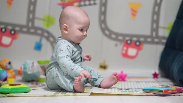 Cute Little Baby Playing with Colorful Toys at Home