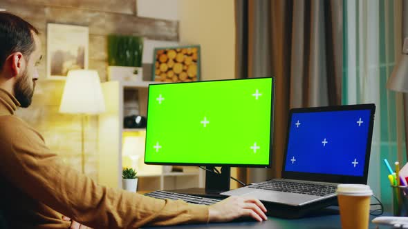 Zoom in Shot of Engineer at This Desk Working on Computer alt