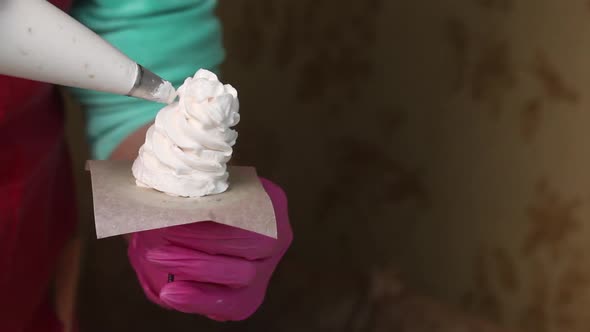 Woman Makes Marshmallow Cones. Using A Pastry Bag. Close Up Shot.. alt