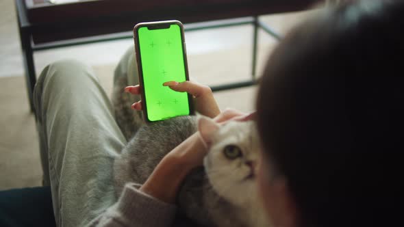 Woman Petting Cat and Using Smartphone with Chroma Key alt