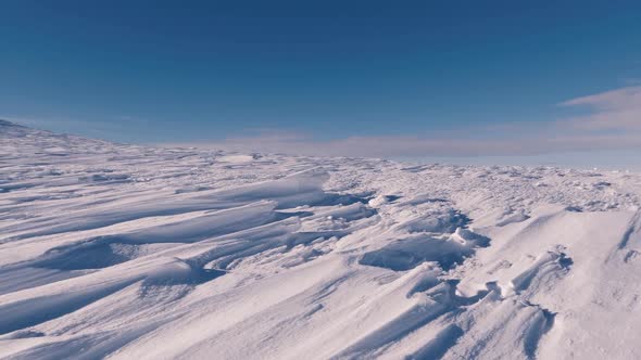 Dolly Shot over Frozen Snowy Structure in Sunny Winter Mountains Pattern Texture Background alt
