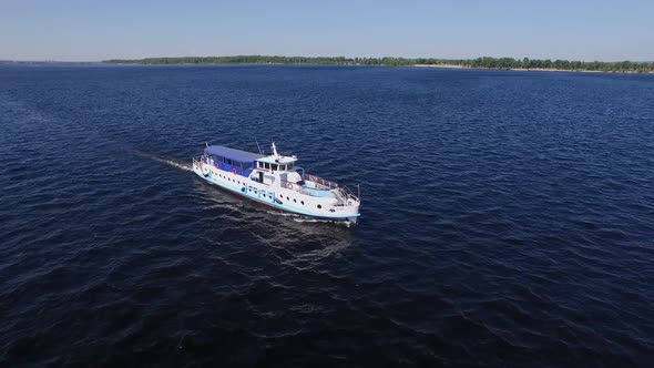 Aerial View of Floating Boat on Wide River in Summer